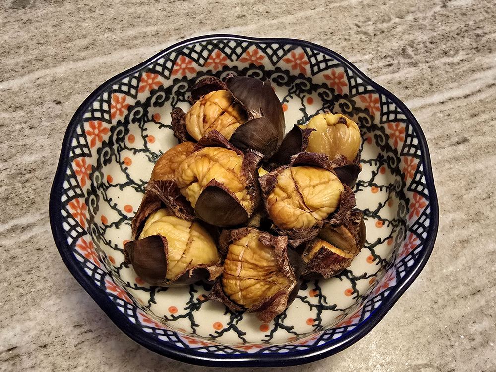 Bolesławiec bowl in use, filled with roasted chestnuts